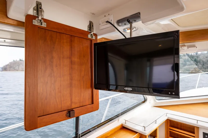 Big Blue Yacht Photos Pics 2010 Back Cove 37 yacht interior with mounted Jensen TV and wooden cabinetry.