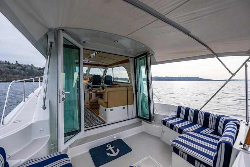 Big Blue Yacht Photos Pics 2010 Back Cove 37 yacht interior with striped seating and scenic water view.