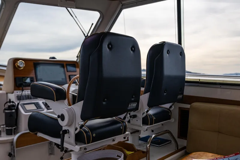 Big Blue Yacht Photos Pics Interior of a 2010 Back Cove 37 boat with two helm seats and navigation equipment.