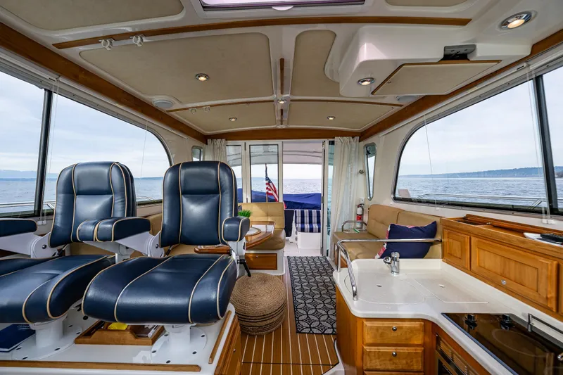 Big Blue Yacht Photos Pics Luxurious interior of a 2010 Back Cove 37 yacht with leather seating and ocean view.