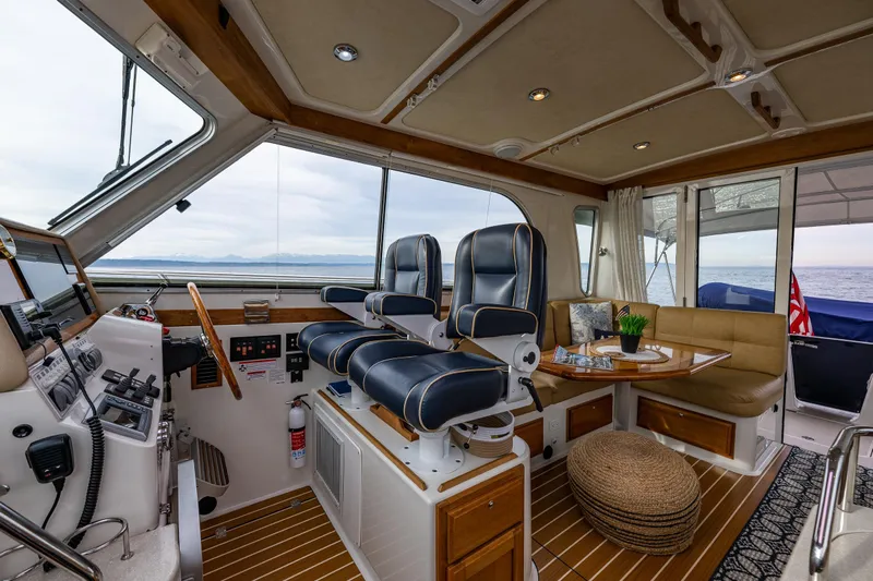 Big Blue Yacht Photos Pics Luxurious 2010 Back Cove 37 yacht interior with helm, seating, and ocean view.