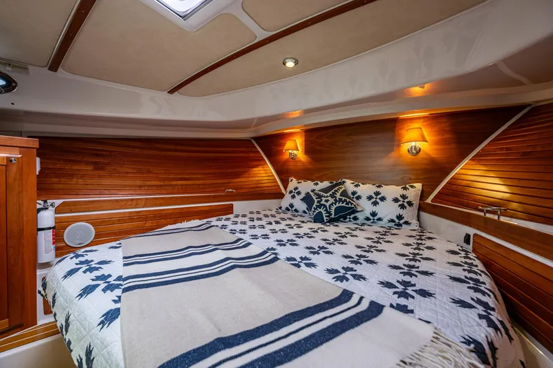 Big Blue Yacht Photos Pics Luxurious cabin interior of 2010 Back Cove 37 yacht with cozy bedding and wooden accents.