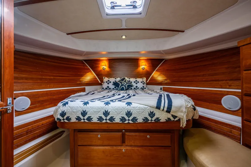 Big Blue Yacht Photos Pics Luxurious cabin interior of 2010 Back Cove 37 yacht with cozy bed and wooden accents.