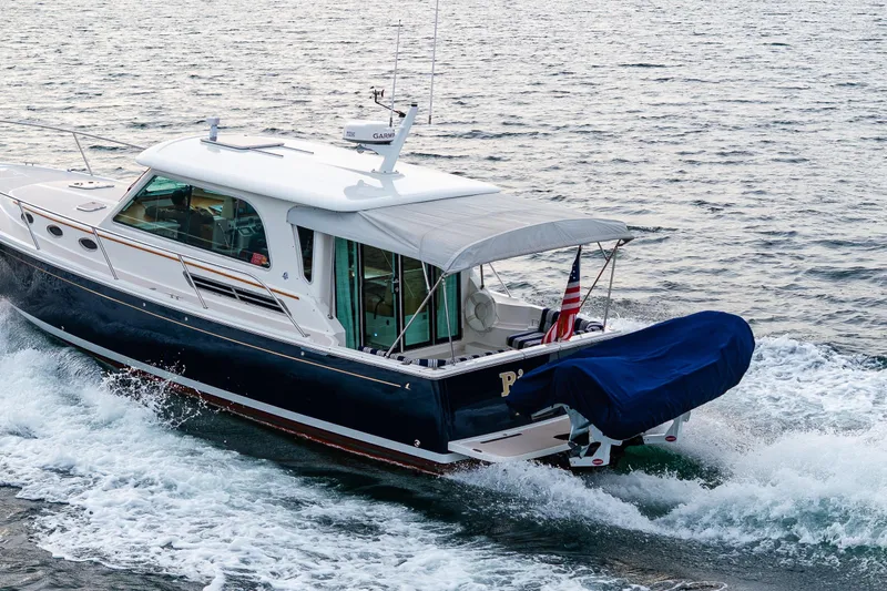 Big Blue Yacht Photos Pics 2010 Back Cove 37 yacht cruising on open water, featuring sleek design and American flag.