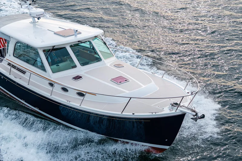 Big Blue Yacht Photos Pics 2010 Back Cove 37 yacht cruising on open water, showcasing sleek design and craftsmanship.