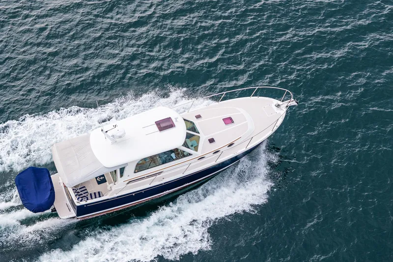 Big Blue Yacht Photos Pics 2010 Back Cove 37 yacht cruising on open water, aerial view.