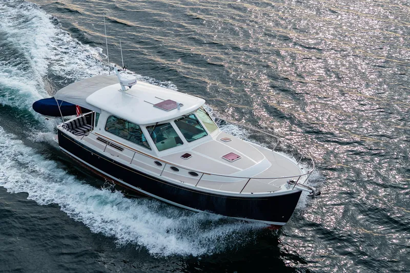 Big Blue Yacht Photos Pics 2010 Back Cove 37 yacht cruising on open water, creating a wake.