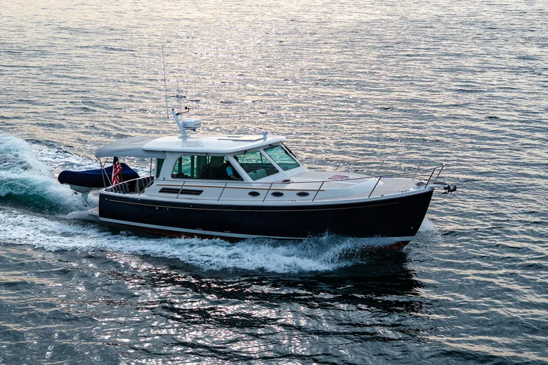 Big Blue Yacht Photos Pics 2010 Back Cove 37 yacht cruising on open water at sunset.