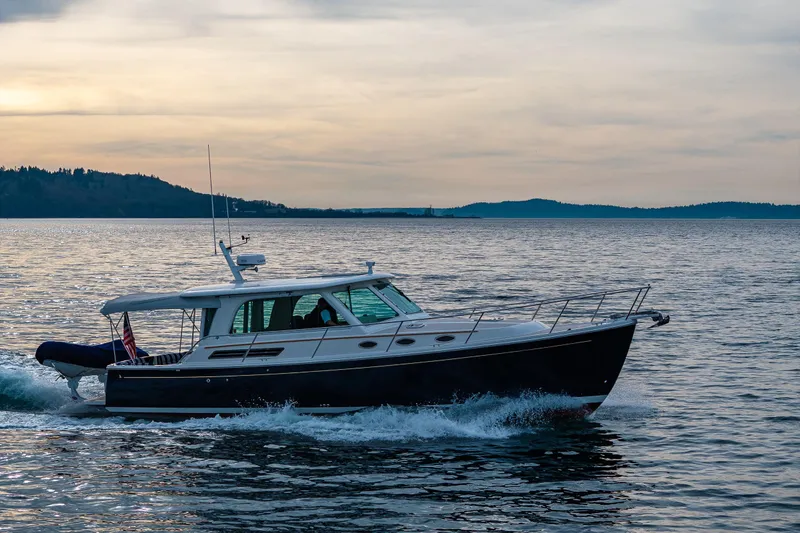 Big Blue Yacht Photos Pics 2010 Back Cove 37 yacht cruising on calm waters at sunset.