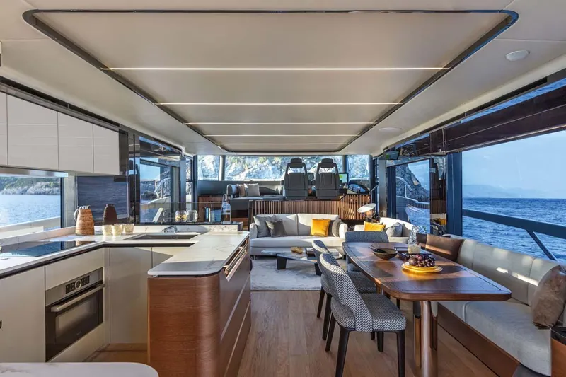  Yacht Photos Pics Manufacturer Provided Image: Luxurious interior of the 2022 Absolute 64 Navetta yacht with modern kitchen and dining area.
