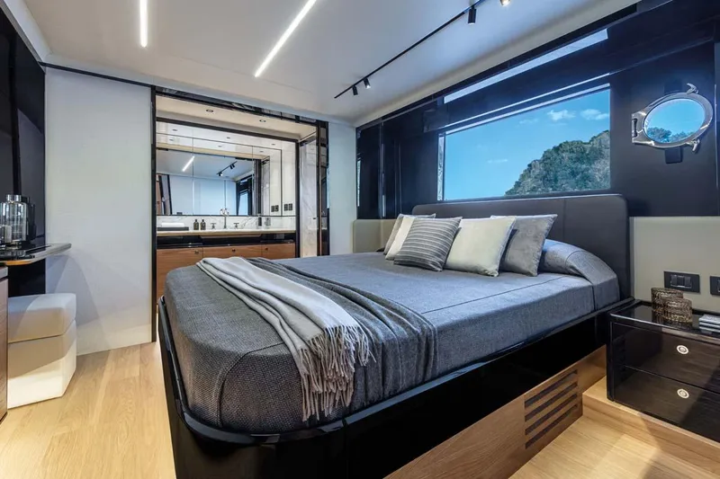  Yacht Photos Pics Manufacturer Provided Image: Luxurious bedroom interior of 2022 Absolute 64 Navetta yacht with modern design and scenic window view.