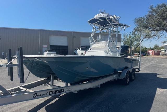 2016 Dargel Kat 250 HDX boat on trailer, parked outside industrial building.