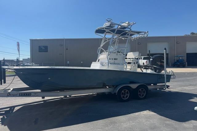 2016 Dargel Kat 250 HDX boat on trailer, parked outside industrial building.
