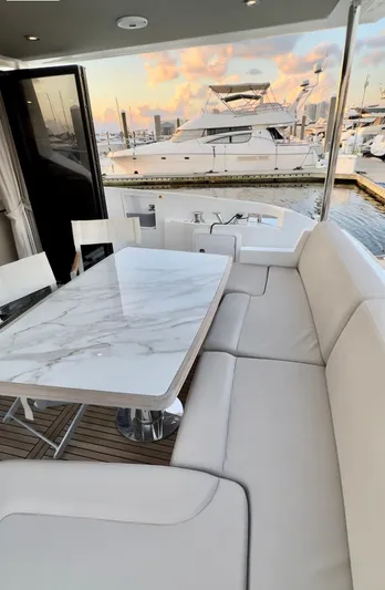 Kara Mia II Yacht Photos Pics Luxurious seating area on 2019 Azimut 55 Motor Yacht with marina view.