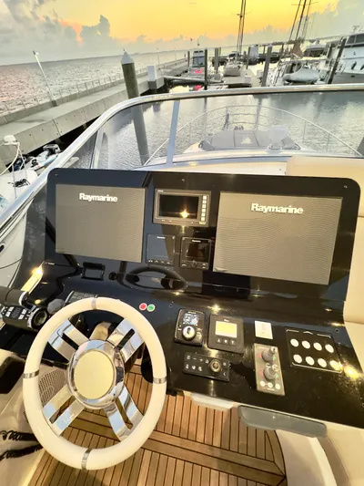 Kara Mia II Yacht Photos Pics Azimut 55 Motor Yacht 2019 helm with Raymarine electronics at sunset in marina.