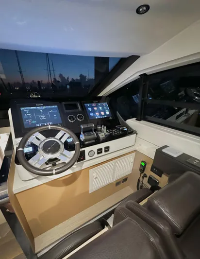 Kara Mia II Yacht Photos Pics 2019 Azimut 55 Motor Yacht helm with modern controls and navigation screens at sunset.