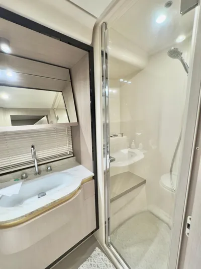 Kara Mia II Yacht Photos Pics Luxurious bathroom in 2019 Azimut 55 Motor Yacht with modern fixtures and shower.