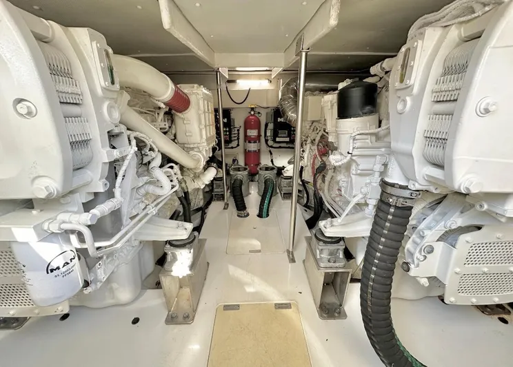 Kara Mia II Yacht Photos Pics Engine room of 2019 Azimut 55 Motor Yacht, featuring dual engines and fire extinguisher.