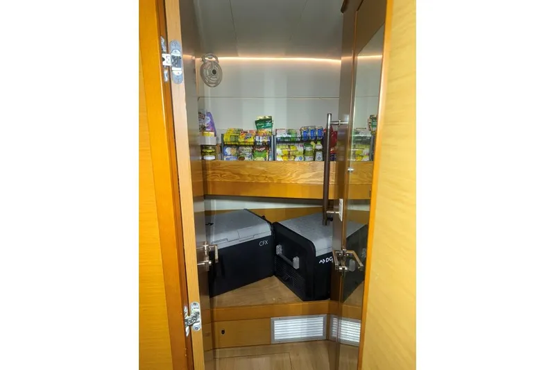 Nauti Adventure Yacht Photos Pics Pantry inside 2015 Lagoon 52 F yacht with shelves and storage boxes.
