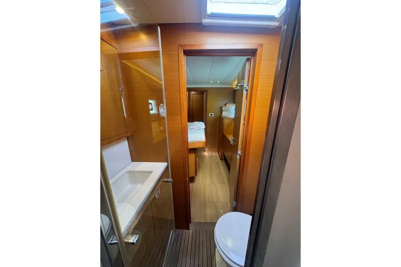 Nauti Adventure Yacht Photos Pics Interior of 2015 Lagoon 52 F yacht, featuring a bathroom and cabin with wooden finishes.