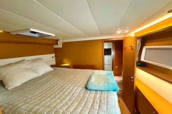 Nauti Adventure Yacht Photos Pics Luxurious cabin interior of 2015 Lagoon 52 F yacht with cozy bedding.