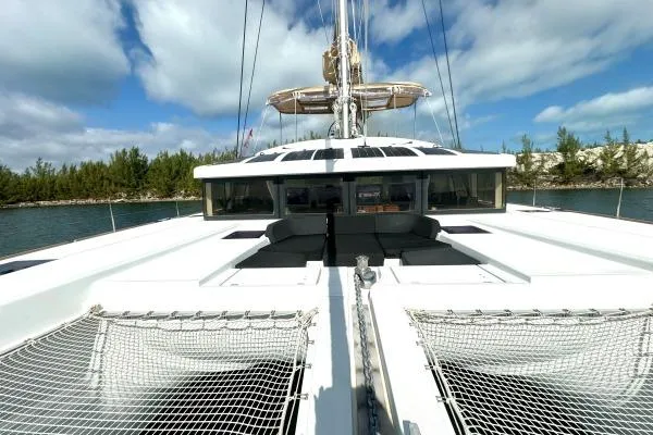 Nauti Adventure Yacht Photos Pics 2015 Lagoon 52 F catamaran with spacious deck and netting, set against a scenic waterway.