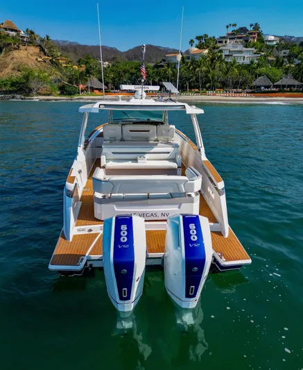 Oso Del Mar Yacht Photos Pics 2022 Tiara Yachts 43 LS with twin 600 V12 engines, docked near a tropical shoreline.