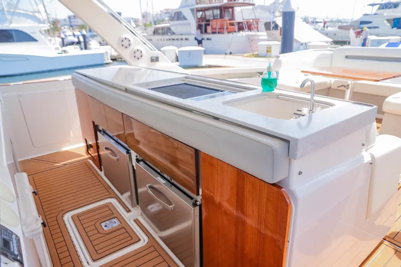 Oso Del Mar Yacht Photos Pics Luxury outdoor kitchen on 2022 Tiara Yachts 43 LS, featuring sink and storage.