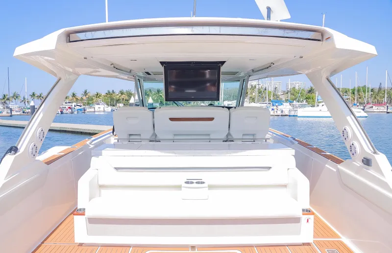 Oso Del Mar Yacht Photos Pics 2022 Tiara Yachts 43 LS luxury yacht interior with seating and TV, docked at marina.