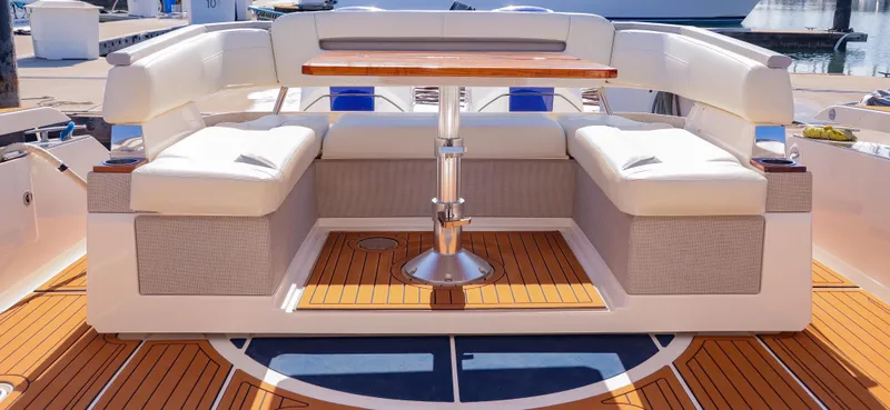 Oso Del Mar Yacht Photos Pics Luxury seating area on 2022 Tiara Yachts 43 LS with elegant wooden table.