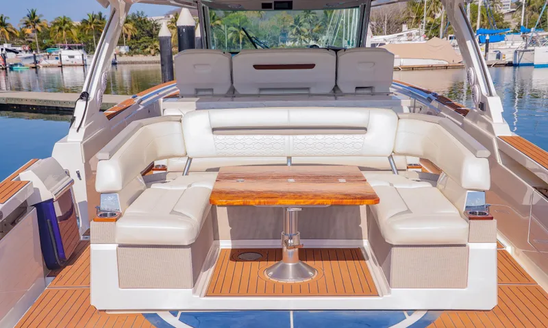 Oso Del Mar Yacht Photos Pics Luxurious 2022 Tiara Yachts 43 LS with elegant seating and wooden table on deck.