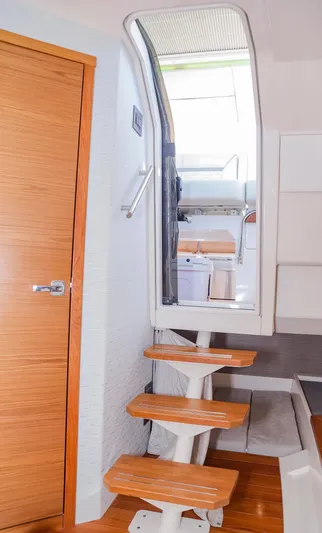 Oso Del Mar Yacht Photos Pics Interior stairs of 2022 Tiara Yachts 43 LS, featuring wooden steps and modern design.