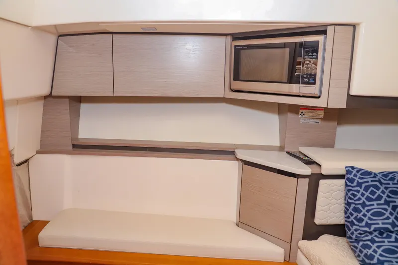 Oso Del Mar Yacht Photos Pics Interior of 2022 Tiara Yachts 43 LS with microwave and seating area.
