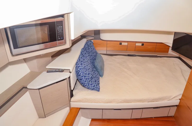 Oso Del Mar Yacht Photos Pics 2022 Tiara Yachts 43 LS interior cabin with bed, microwave, and modern design.