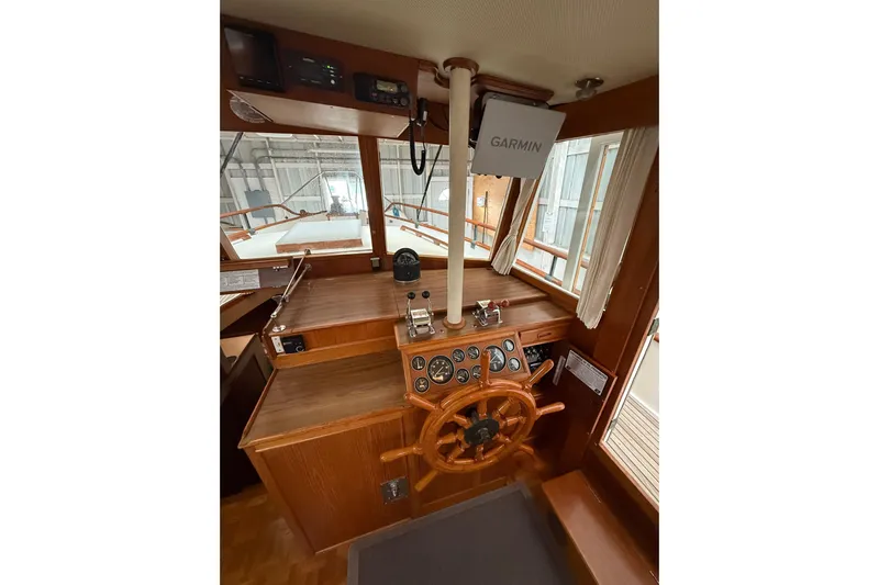  Yacht Photos Pics Interior helm of 1981 Grand Banks 42 Classic with wooden steering wheel and Garmin equipment.