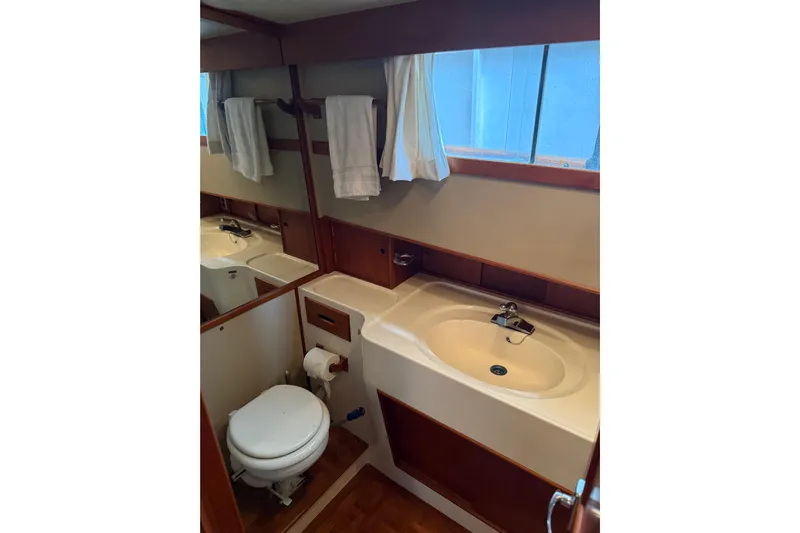  Yacht Photos Pics 1981 Grand Banks 42 Classic yacht bathroom with sink, toilet, and mirror.