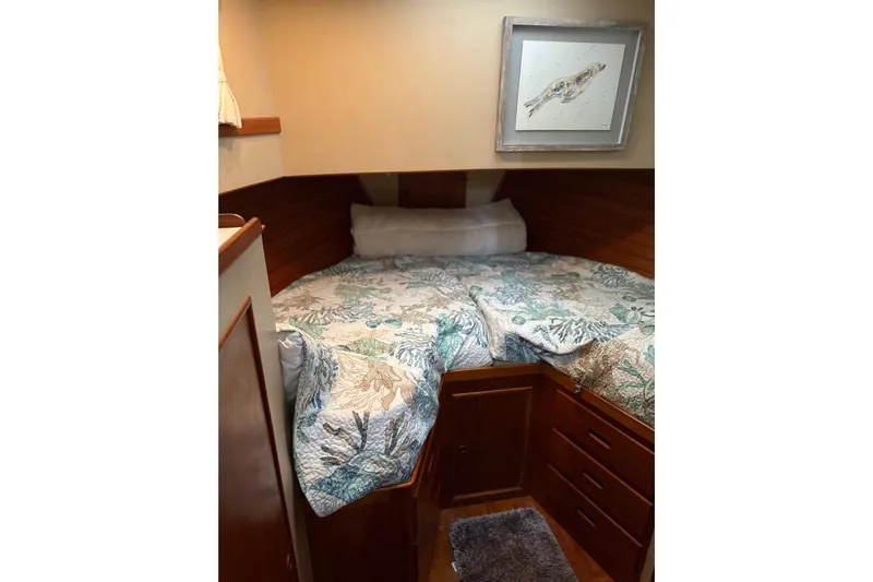  Yacht Photos Pics Cozy cabin interior of 1981 Grand Banks 42 Classic with nautical-themed bedding.