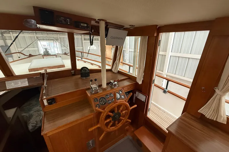  Yacht Photos Pics 1981 Grand Banks 42 Classic helm with wooden wheel and Garmin navigation system.