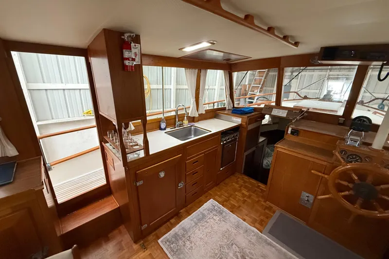  Yacht Photos Pics Interior of 1981 Grand Banks 42 Classic yacht with wooden cabinetry and helm.