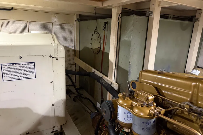  Yacht Photos Pics Engine room of 1981 Grand Banks 42 Classic with visible machinery and warning sign.