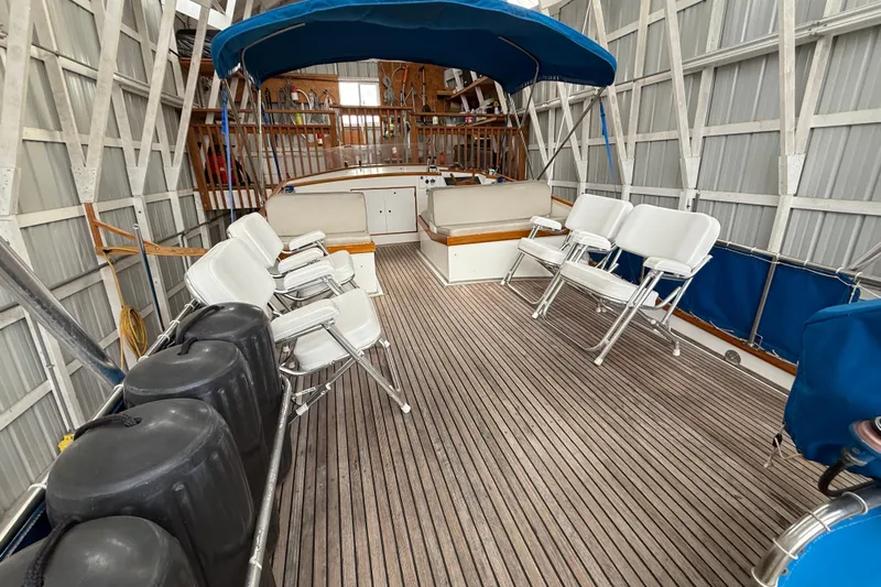  Yacht Photos Pics 1981 Grand Banks 42 Classic yacht interior with seating and canopy in a docked setting.