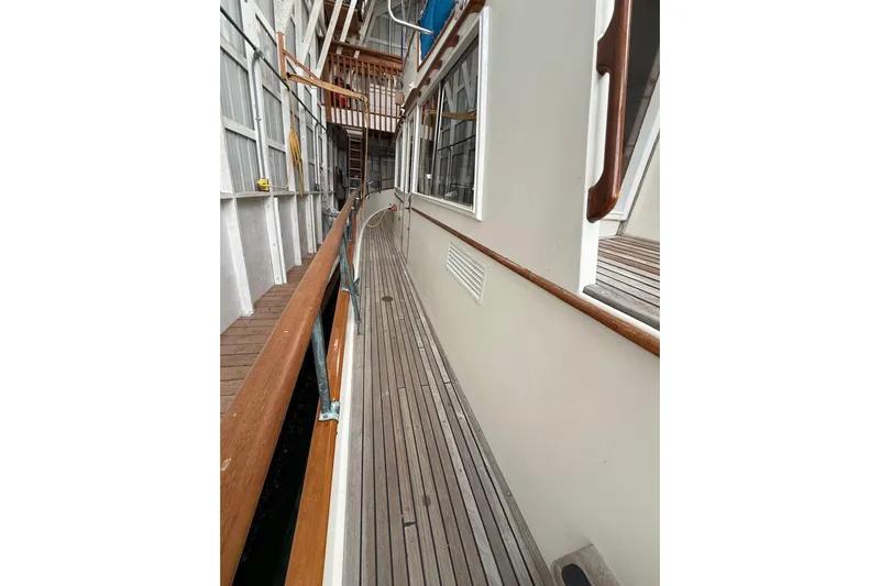  Yacht Photos Pics Side deck of a 1981 Grand Banks 42 Classic yacht with wooden railings.