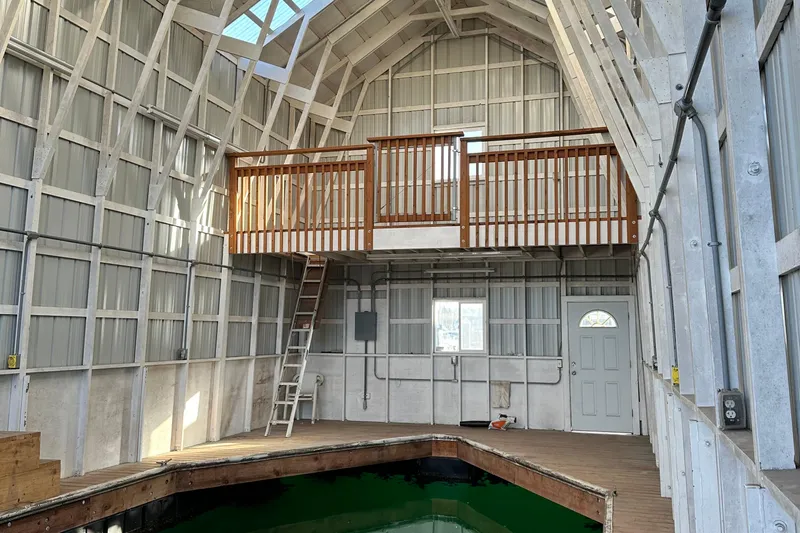  Yacht Photos Pics Interior of a boathouse with loft, ladder, and water access for a 1981 Grand Banks Classic Tri-cabin.