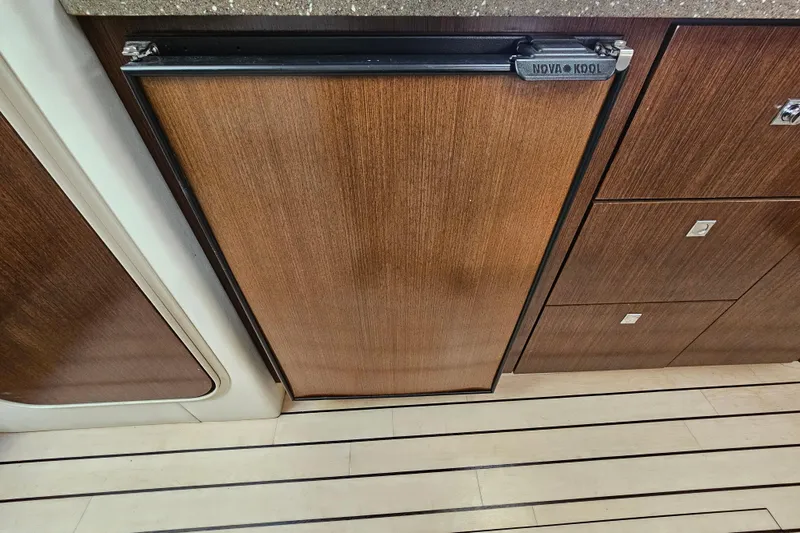 Moxie Spirt Yacht Photos Pics 2012 Cruisers Yachts 350 Express interior with wood paneling and Nova Kool fridge.