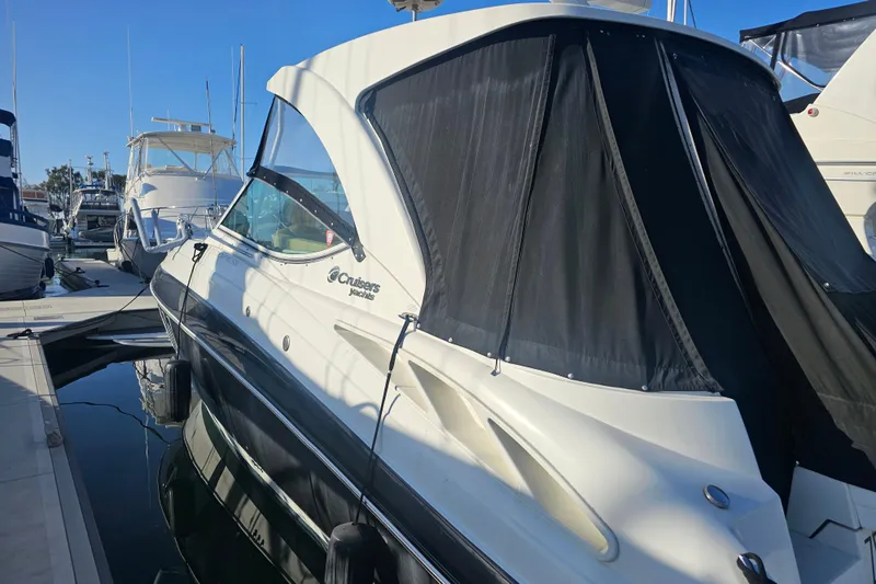 Moxie Spirt Yacht Photos Pics 2012 Cruisers Yachts 350 Express docked at marina, featuring sleek design and black canopy.