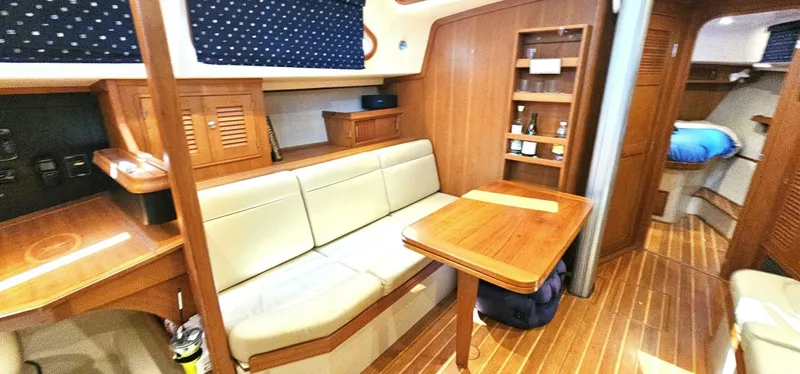  Yacht Photos Pics Cozy interior of 2009 Island Packet 465 yacht with wooden furnishings and seating area.