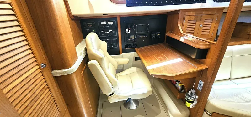  Yacht Photos Pics Navigation station in 2009 Island Packet 465 yacht with wooden desk and beige chair.