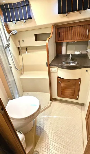  Yacht Photos Pics 2009 Island Packet 465 yacht bathroom with shower, sink, and wooden cabinetry.