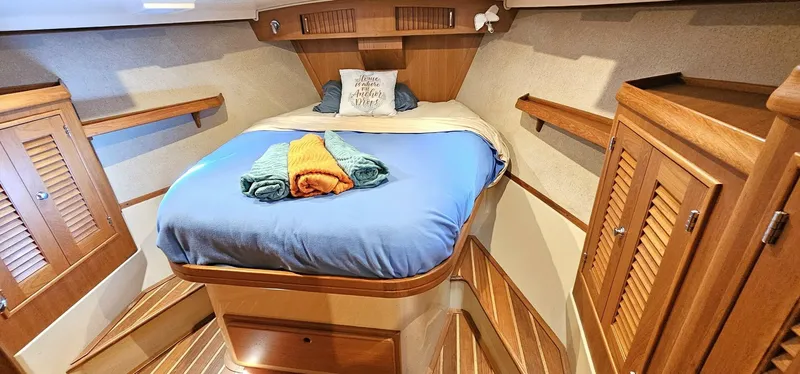  Yacht Photos Pics Luxurious cabin interior of 2009 Island Packet 465 yacht with cozy bed and wooden finishes.