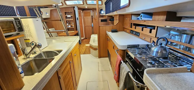  Yacht Photos Pics Interior of 2009 Island Packet 465 yacht with kitchen and dining area.